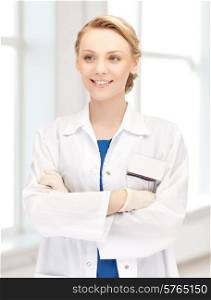 medicine, people, profession and healthcare concept - smiling young female doctor in white coat in hospital