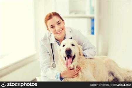 medicine, pet, animals, health care and people concept - happy veterinarian or doctor with golden retriever dog at vet clinic
