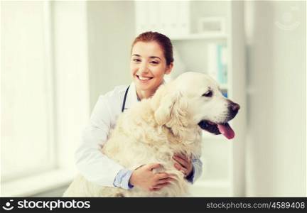 medicine, pet, animals, health care and people concept - happy veterinarian or doctor with golden retriever dog at vet clinic