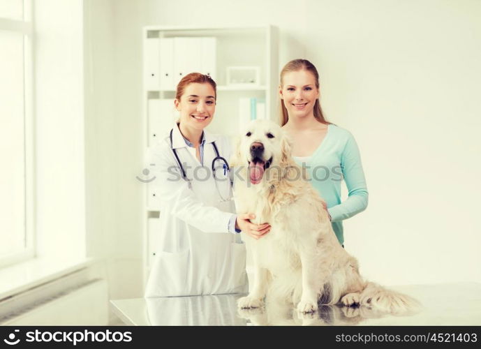 medicine, pet, animals, health care and people concept - happy woman with golden retriever dog and veterinarian doctor at vet clinic