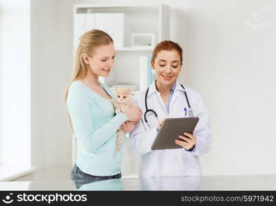 medicine, pet, health care, technology and people concept - happy woman and veterinarian doctor with tablet pc computer checking scottish fold kitten up at vet clinic