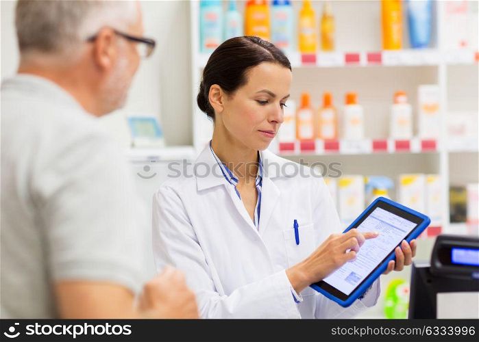 medicine, pharmaceutics, healthcare and technology concept - apothecary and senior customer with tablet pc computer at pharmacy. apothecary and customer with tablet pc at pharmacy