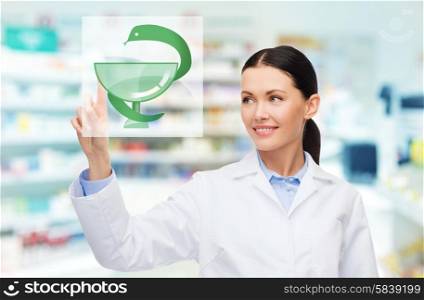 medicine, pharmacy, people, health care and pharmacology concept - happy young woman pharmacist with medical symbol of snake and cup over drugstore background