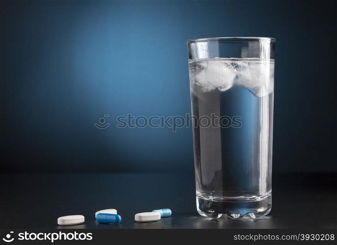 Medicine pills and glass of cold drink water. Medicine pills and glass of drink water