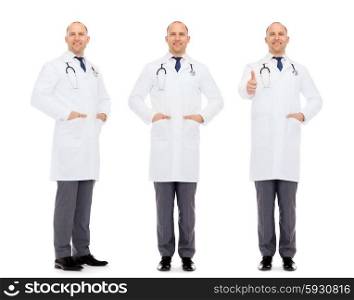 medicine, profession and health care concept - happy doctors with stethoscope showing thumbs up
