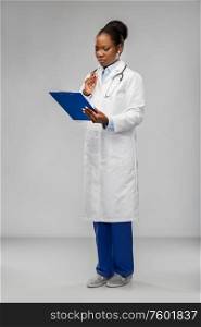 medicine, profession and healthcare concept - african american female doctor or scientist in white coat with clipboard and stethoscope over grey background. african american female doctor with clipboard