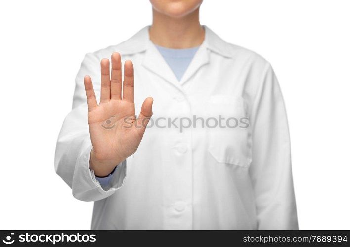 medicine, profession and healthcare concept - close up of female doctor in white coat showing stop gesture. female doctor in white coat showing stop gesture