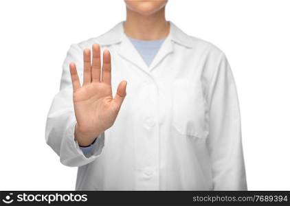 medicine, profession and healthcare concept - close up of female doctor in white coat showing stop gesture. female doctor in white coat showing stop gesture