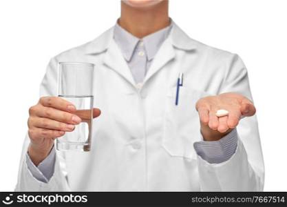 medicine, profession and healthcare concept - close up of female doctor with pill and glass of water over white background. female doctor with medicine and glass of water