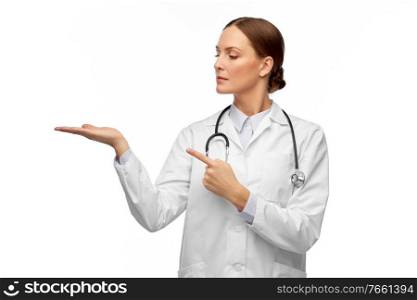 medicine, profession and healthcare concept - female doctor in white coat with stethoscope holding something invisible on her hand. female doctor holding something on her hand