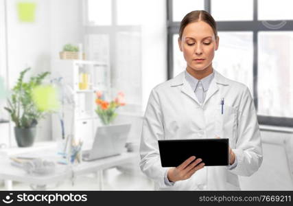 medicine, profession and healthcare concept - female doctor in white coat with tablet pc computer over medical office at hospital on background. female doctor with tablet computer at hospital