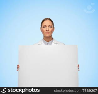 medicine, profession and healthcare concept - female doctor or scientist holding white board over blue background. female doctor or scientist holding white board