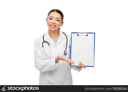 medicine, profession and healthcare concept - happy smiling asian female doctor in white coat showing clipboard. happy smiling asian female doctor with clipboard