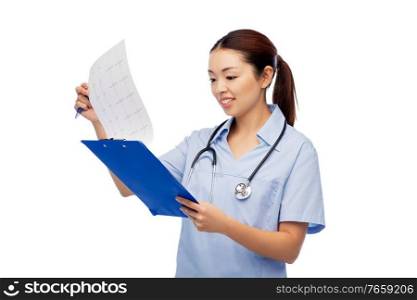 medicine, profession and healthcare concept - happy smiling asian female doctor or nurse in blue uniform with cardiogram on clipboard over white background. happy smiling asian female doctor with cardiogram