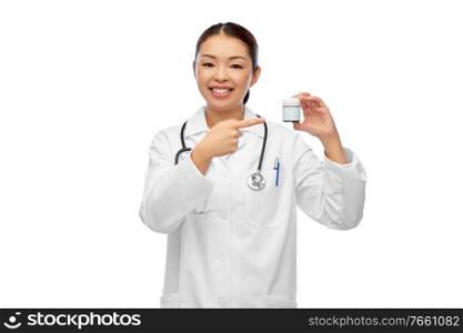 medicine, profession and healthcare concept - happy smiling asian female doctor or nurse with stethoscope holding jar of pills over white background. smiling asian female doctor or nurse with medicine