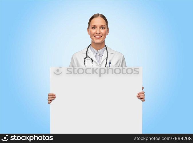 medicine, profession and healthcare concept - happy smiling female doctor holding white board over blue background. happy smiling female doctor holding white board