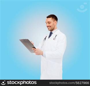 medicine, profession, and healthcare concept - smiling male doctor with clipboard and stethoscope writing prescription over white background