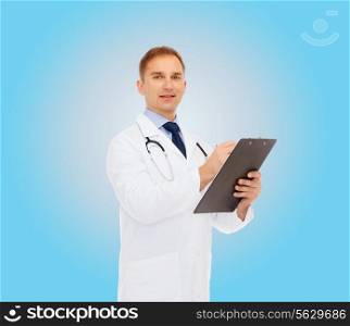 medicine, profession and healthcare concept - smiling male doctor with clipboard and stethoscope writing prescription over blue background