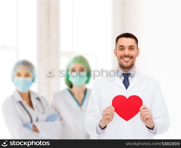 medicine, profession, and healthcare concept - smiling male doctor with red heart