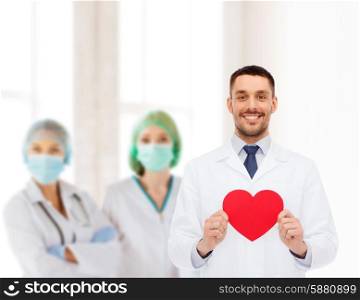medicine, profession, and healthcare concept - smiling male doctor with red heart