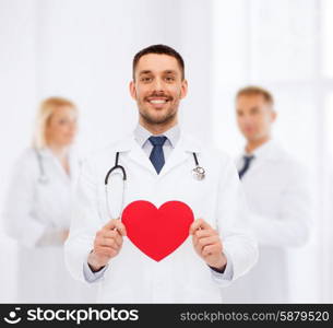 medicine, profession, and healthcare concept - smiling male doctor with red heart and stethoscope