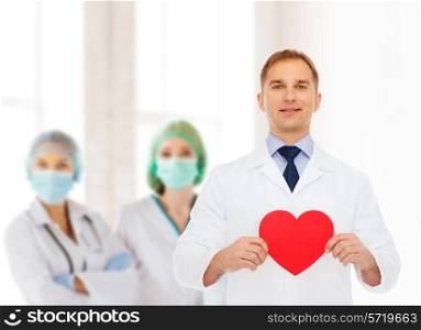 medicine, profession, charity and healthcare concept - smiling male doctor with red heart over group of medics