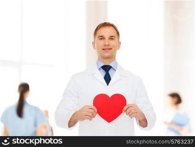 medicine, profession, charity and healthcare concept - smiling male doctor with red heart over group of medics