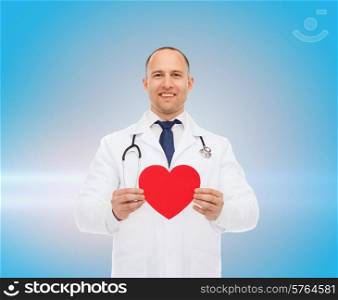 medicine, profession, charity and healthcare concept - smiling male doctor with red heart and stethoscope over blue background