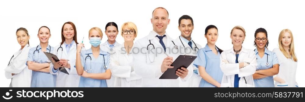 medicine, profession, teamwork and healthcare concept - international group of smiling medics or doctors with clipboard and stethoscopes over white background