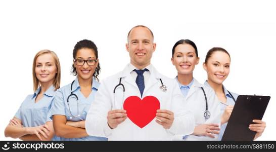 medicine, profession, teamwork and healthcare concept - international group of smiling medics or doctors with clipboard and stethoscopes holding red paper heart shape over white background
