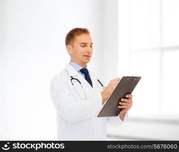 medicine, profession, workplace and healthcare concept - smiling male doctor with clipboard and stethoscope over white room background