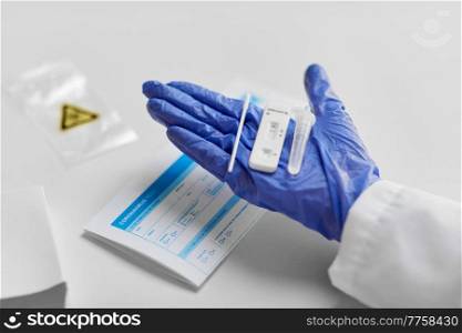 medicine, quarantine and pandemic concept - close up of doctor’s hand in medical glove holding negative self testing coronavirus test on white background. close up of hand with negative coronavirus test