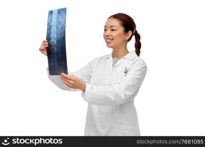medicine, radiology and healthcare concept - happy smiling asian female doctor in white coat looking at x-ray scan image of spine. asian female doctor looking at x-ray of spine