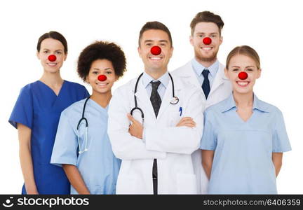 medicine, red nose day and healthcare concept - international group of smiling doctors and nurses with stethoscopes over white background. group of happy doctors at hospital