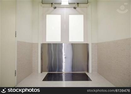 medicine, science, health care, emergency and interior concept - doors at hospital or laboratory corridor
