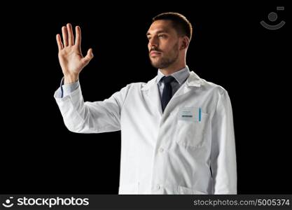 medicine, science, healthcare and people concept - doctor or scientist in white coat touching something invisible over black background. doctor or scientist in white coat
