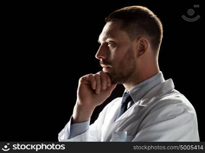 medicine, science, healthcare and people concept - male doctor or scientist in white coat over black background. doctor or scientist in white coat