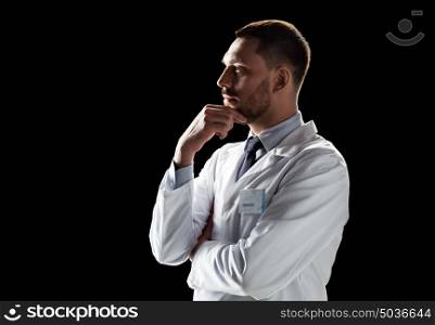 medicine, science, healthcare and people concept - male doctor or scientist in white coat over black background. doctor or scientist in white coat