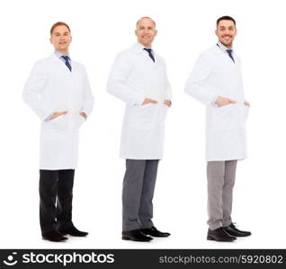 medicine, science, profession and health care concept - happy doctors in white coat