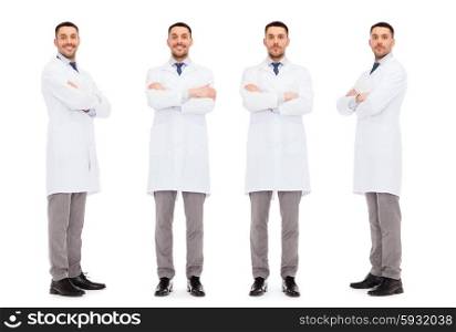 medicine, science, profession and health care concept - happy doctors in white coat