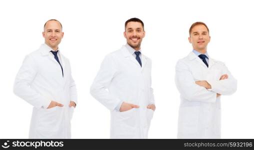 medicine, science, profession and health care concept - happy doctors in white coat