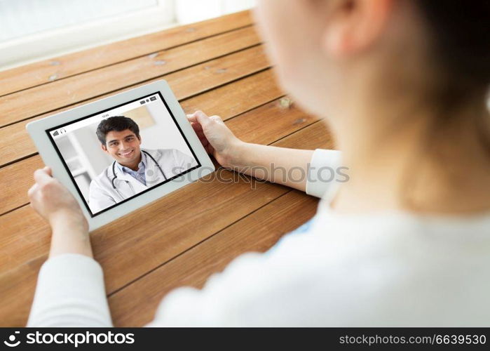 medicine, technology and healthcare concept - close up of woman or patient having video chat with doctor on tablet pc computer at home. patient having video chat with doctor on tablet pc