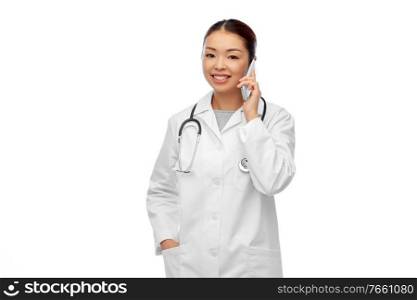 medicine, technology and healthcare concept - happy smiling asian female doctor or nurse with stethoscope calling on smartphone over white background. asian female doctor or nurse calling on smartphone