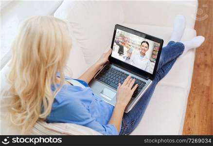 medicine, technology and healthcare concept - woman or customer having video chat with pharmacist on laptop computer at home. woman having video chat with pharmacist on laptop