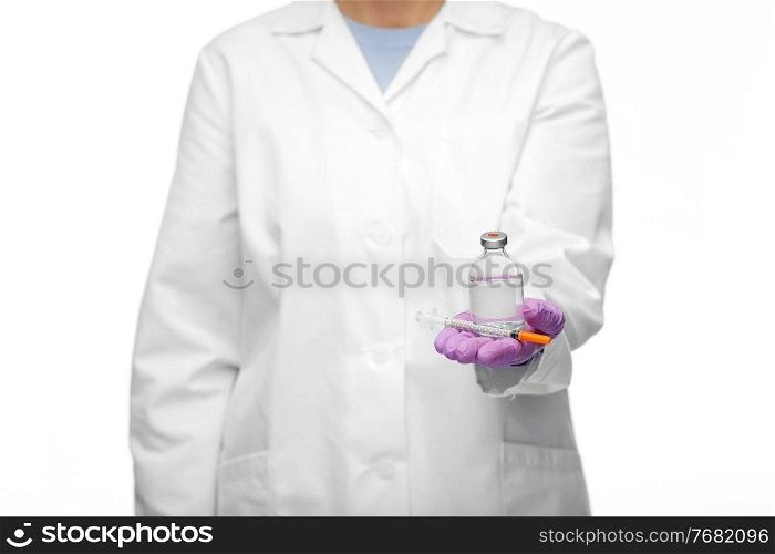 medicine, vaccination and healthcare concept - close up of female doctor or nurse with drug and syringe over white background. close up of doctor with medicine and syringe