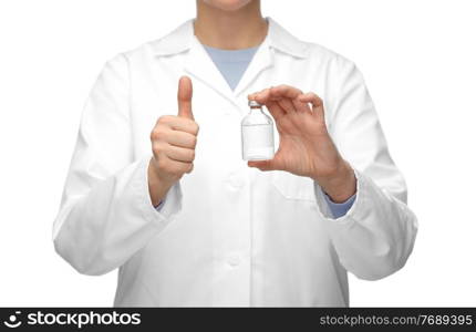 medicine, vaccination and healthcare concept - close up of female doctor or nurse with drug in bottle showing thumbs up over white background. close up of doctor with medicine showing thumbs up