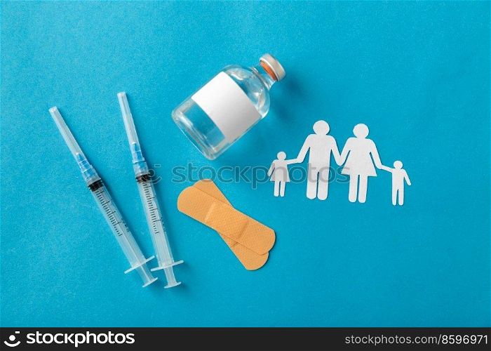 medicine, vaccination and healthcare concept - disposable syringes and family pictogram on blue background. syringes and family pictogram on blue background