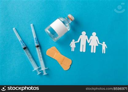 medicine, vaccination and healthcare concept - disposable syringes and family pictogram on blue background. syringes and family pictogram on blue background