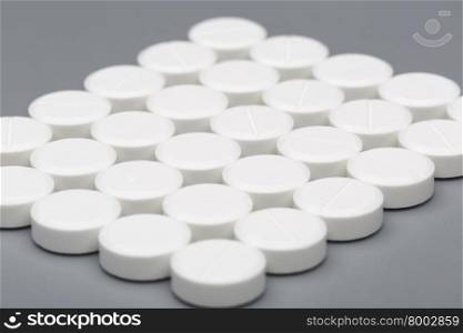 Medicine white pills. Medicine white pills on a gray background