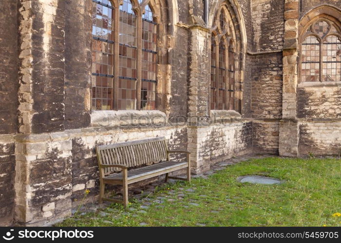 Medieval abbey yard with wooden bench in Gent, Belgium&#xA;